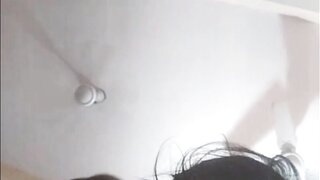Indian girl plays with water bottle.